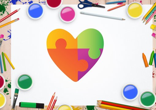 Heart shape on white card against stationary items in background - Powered by Adobe