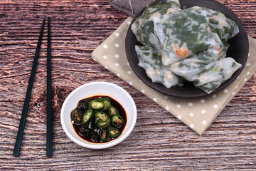 Steamed Dumpling stuffed with garlic chives with spicy soy source.