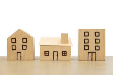 Miniature wooden houses on white background. Clipping paths included