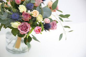 Glass vase with beautiful bouquet on light background