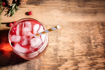 Glass of delicious wine spritzer on wooden table