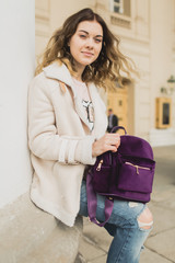 Young woman walking in the city in the spring