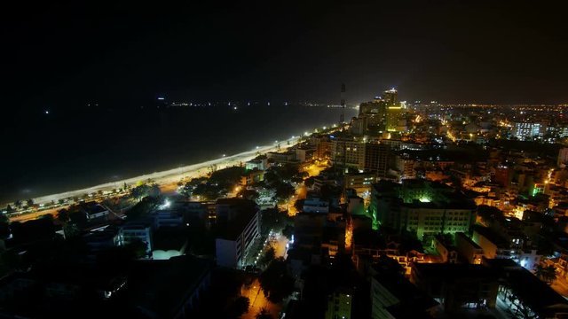 View of the night city and the sea. Timelapse