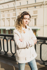 Young woman walking in the city in the spring