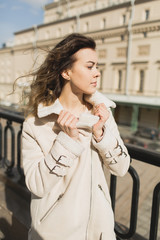 Young woman walking in the city in the spring