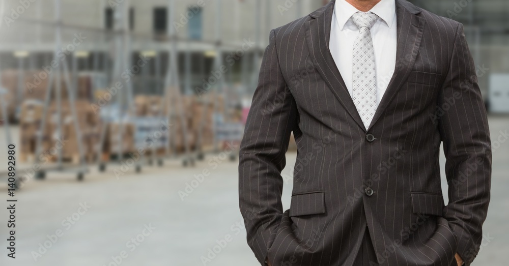 Canvas Prints Businessman standing with hands in pocket at factory