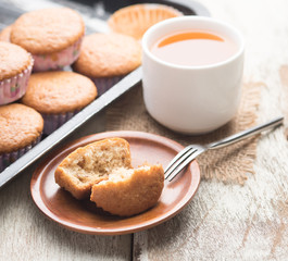 banana muffins cake with tea cup on wood background