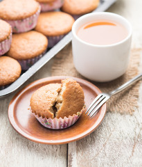 banana muffins cake with tea cup on wood background