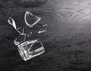 broken glass on dark wood background, concept of danger © showcake