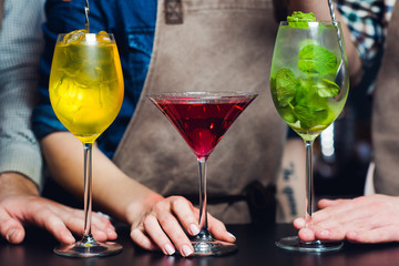 Barmen offering exotic sweet cocktails in restaurant