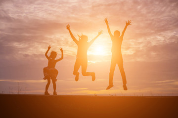 Fototapeta premium Brother and brother silhouette,Moments of the child's joy. On the Nature sunset