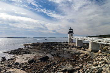 Fototapeta na wymiar Marshall Point Light as seen from the rocky coast of Port Clyde, Maine.