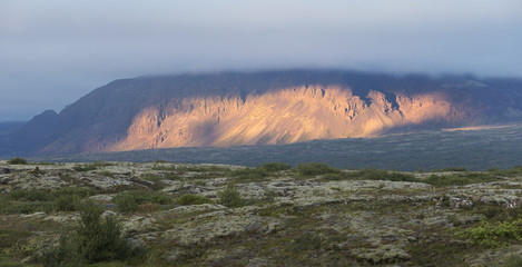 Typical icelandic landscape with volcano at sunset.