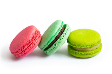 Multicolored macaroon cookies on a white background.