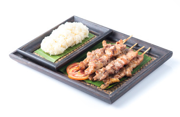 Thai styled grilled pork and sticky rice isolated on white