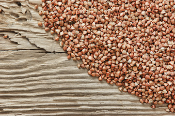 Obraz premium buckwheat groats on a wooden table