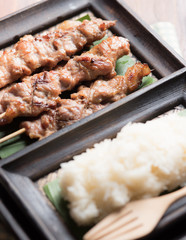 Thai styled grilled pork and sticky rice on wood