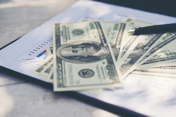 Money with document,Graph and chart sheet ,pen ,glasses on desk. Accounting , accounts concept.