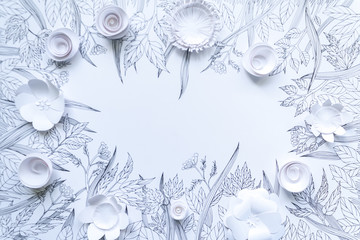 frame from 3d paper flowers with painted leaves and stems on the white background