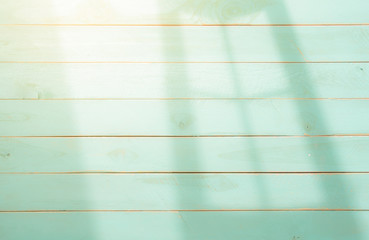 Fototapeta premium Wooden background with shadows from a window frame,morning light