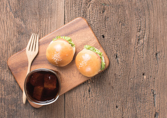 Homemade burger and Cold drink cola on wooden background,top view