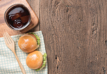 Homemade burger and Cold drink cola on wooden background,top view