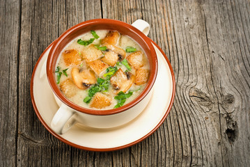 Bowl of cream of mushroom soup with fried mushrooms