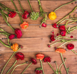 Ranunkulyus bouquet of red flowers on a wooden background