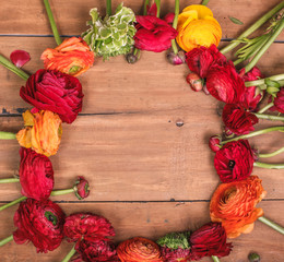 Ranunkulyus bouquet of red flowers on a wooden background