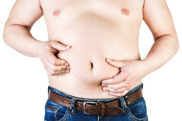 Naklejka premium Excess body weight of a man with his hands touching fat on his stomach is the concept of obesity. Not the right food.