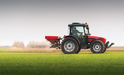 Tractor spreading artificial fertilizers