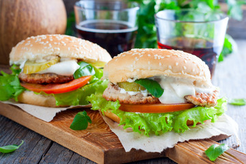 Homemade hamburger with beef, onions, tomatoes, salad and cheese on a wooden board, Horizontal