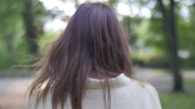 Nice girl walking in park in spring