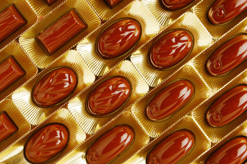 chocolate candies in a gold gift box