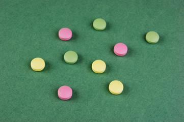 Pills and tablets on a green background