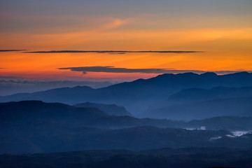 Fototapeta na wymiar Clouds over the valley on early morning before sunrise from Sri Pada (Adam's Peak), Sri Lanka.