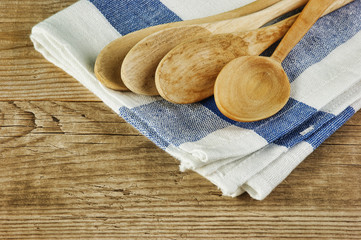 wooden spoon and dishcloth on old wooden table