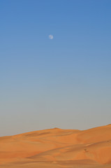 Moon Over Desert In Daytime