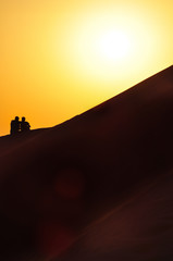 Silhouette Couple On A Desert Sand Dune
