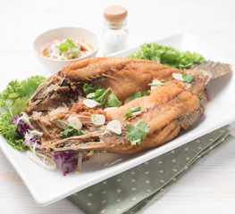 Deep Fried Snapper topped with Sweet Fish Sauce on wood,Thai Food