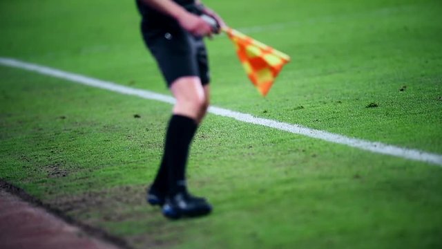 Assistant referee moving along the sideline during a soccer match