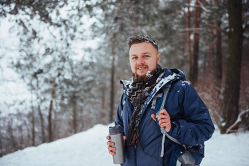 Man Traveler with backpack hiking Travel Lifestyle adventure concept active vacations outdoor. Beautiful landscape  forest