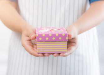 Hand holding small box for a gift
