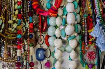 Handmade beads and jewellery hanging from wall