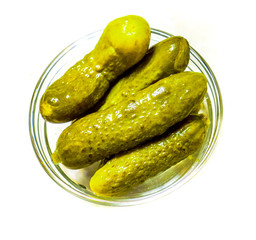 Pickled green gherkins in small glass plate