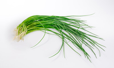 Spring onions laying on white background