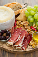appetizer cheese with smoked meat on board