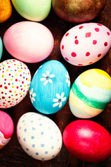 Easter eggs in nest on rustic wooden planks with copyspace. Happy Easter!.