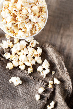 Popcorn on dark background with copyspace, cinema, movies and entertainment concept .