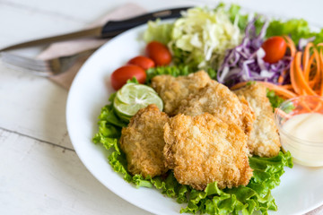 Crispy fried fish fillet with vegetables